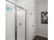 Modern bathroom with a glass shower door, white subway tile, and silver fixtures at 216 Ellis Ln, Woodstock, GA 30189