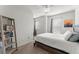 Bright bedroom with a ceiling fan, neutral walls, and a wooden bookshelf at 216 Ellis Ln, Woodstock, GA 30189