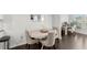 Cozy dining area with dark hardwood floors, an ornamental mirror, and a modern table at 216 Ellis Ln, Woodstock, GA 30189