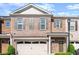 Charming brick townhome with a welcoming two-car garage and well-maintained landscaping at 216 Ellis Ln, Woodstock, GA 30189