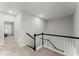 Upstairs hallway featuring carpet and a black-and-white railing at 216 Ellis Ln, Woodstock, GA 30189