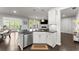 Bright kitchen featuring stainless steel appliances, white cabinetry, and a granite countertop island at 216 Ellis Ln, Woodstock, GA 30189