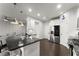 Open kitchen with a breakfast bar, stainless steel appliances, and views into the living room at 216 Ellis Ln, Woodstock, GA 30189