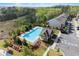 A swimming pool offers recreation next to modern townhouses and lush greenery at 216 Ellis Ln, Woodstock, GA 30189