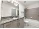 Bathroom with granite countertops, modern vanity, tiled shower, and a large mirror providing ample lighting at 250 Pharr Ne Rd # 905, Atlanta, GA 30305