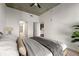 Bedroom with ceiling fan, large bed with stylish grey blanket and glimpses into the en-suite bathroom at 250 Pharr Ne Rd # 905, Atlanta, GA 30305