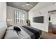Bedroom with ceiling fan, large window offering city views, and modern tv mounted on the wall at 250 Pharr Ne Rd # 905, Atlanta, GA 30305