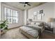 Cozy bedroom with a large window offering city views, comfortable bed, modern lamps, and stylish wall art at 250 Pharr Ne Rd # 905, Atlanta, GA 30305