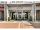 The Eclipse Buckhead building entrance with large glass windows and meticulously maintained landscaping at 250 Pharr Ne Rd # 905, Atlanta, GA 30305