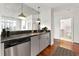 Contemporary kitchen featuring stainless steel appliances, tile backsplash, and views into the bathroom at 250 Pharr Ne Rd # 905, Atlanta, GA 30305
