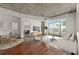 Bright living room with hardwood floors, modern lighting, and sliding glass doors to a balcony at 250 Pharr Ne Rd # 905, Atlanta, GA 30305