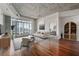 Spacious living room with hardwood floors, balcony access, and a view into the bedroom at 250 Pharr Ne Rd # 905, Atlanta, GA 30305