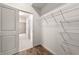 Walk-in closet featuring wire shelving and access to the en-suite bathroom with tiled floors and a bathtub at 250 Pharr Ne Rd # 905, Atlanta, GA 30305