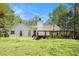 Exterior view of home showing the deck, chimney and a beautiful, well-maintained lawn, creating a serene outdoor space at 285 Willow Shoals Dr, Covington, GA 30016