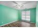 Bright bedroom with a ceiling fan, window, and wood-look flooring at 285 Willow Shoals Dr, Covington, GA 30016