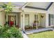 Inviting front porch with seating area, red door, and decorative accents, perfect for relaxing at 285 Willow Shoals Dr, Covington, GA 30016