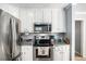 Updated kitchen featuring stainless steel appliances and white cabinetry at 285 Willow Shoals Dr, Covington, GA 30016