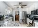 Efficient kitchen featuring granite countertops, stainless steel appliances, and white cabinetry at 285 Willow Shoals Dr, Covington, GA 30016