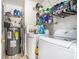 A fully equipped laundry room with washer, dryer, and water heater at 285 Willow Shoals Dr, Covington, GA 30016