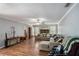 Cozy living room featuring wood floors, stone fireplace, and comfortable sectional sofa at 285 Willow Shoals Dr, Covington, GA 30016