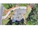 An aerial view of a home showcasing its roofline, driveway, and landscaped grounds at 4505 Whitestone Way, Suwanee, GA 30024