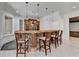 Basement bar with stone accents, pendant lights, and seating for four at 4505 Whitestone Way, Suwanee, GA 30024