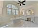 Bright bathroom featuring double sinks, vanity, tile floors and a free-standing tub at 4505 Whitestone Way, Suwanee, GA 30024