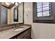 Charming bathroom with a granite countertop, white walls, and shuttered windows at 4505 Whitestone Way, Suwanee, GA 30024