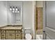 Well-lit bathroom featuring granite countertops and tiled shower at 4505 Whitestone Way, Suwanee, GA 30024