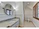 Bright bathroom featuring tiled floors, wainscotting, and a framed mirror at 4505 Whitestone Way, Suwanee, GA 30024