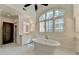 Elegant bathroom features a freestanding tub and a large window at 4505 Whitestone Way, Suwanee, GA 30024