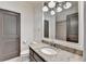 Bathroom with a granite countertop vanity and ample lighting at 4505 Whitestone Way, Suwanee, GA 30024