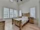 Airy bedroom with a rustic wooden bed frame and plantation shutters at 4505 Whitestone Way, Suwanee, GA 30024