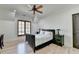 Comfortable bedroom with a ceiling fan, shuttered windows, and bright wood floors at 4505 Whitestone Way, Suwanee, GA 30024