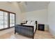 Comfortable bedroom with vaulted ceiling, shuttered windows, and hardwood floors at 4505 Whitestone Way, Suwanee, GA 30024