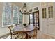 Bright breakfast nook with rustic table, modern light fixture, and built-in storage at 4505 Whitestone Way, Suwanee, GA 30024