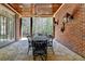 Inviting covered patio with stone flooring, wood ceiling, and outdoor dining area at 4505 Whitestone Way, Suwanee, GA 30024