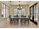 Bright dining room with hardwood floors, large windows, chandelier, and access to outside at 4505 Whitestone Way, Suwanee, GA 30024