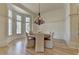 Dining room features hardwood floors, bay window, and chandelier lighting at 4505 Whitestone Way, Suwanee, GA 30024