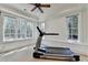This bright exercise room has a ceiling fan and large windows for a comfortable workout at 4505 Whitestone Way, Suwanee, GA 30024