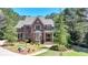 Beautiful brick home with a manicured lawn and lush landscaping, creating a welcoming curb appeal at 4505 Whitestone Way, Suwanee, GA 30024