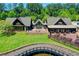 Impressive outdoor entertaining space with multiple seating areas, stone accents, and green grass at 4505 Whitestone Way, Suwanee, GA 30024