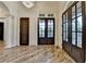 A spacious foyer with a chandelier and glass doors leading outside at 4505 Whitestone Way, Suwanee, GA 30024