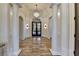 The foyer features marble floors, columns, and a crystal chandelier at 4505 Whitestone Way, Suwanee, GA 30024
