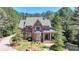 Inviting brick home with manicured front yard, stone accents, and charming covered porch at 4505 Whitestone Way, Suwanee, GA 30024