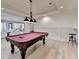 This game room features a billiard table, recessed lights and opens to a Gathering seating area at 4505 Whitestone Way, Suwanee, GA 30024