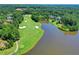 Scenic aerial view of a golf course with lush green fairways and a tranquil lake at 4505 Whitestone Way, Suwanee, GA 30024