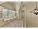 Upstairs hallway with window seat, built-in storage, and bright lighting at 4505 Whitestone Way, Suwanee, GA 30024