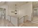 Upstairs hallway with hardwood floors and decorative chandelier at 4505 Whitestone Way, Suwanee, GA 30024