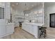 Modern kitchen with white cabinets, a large island, stainless steel appliances, and hardwood floors at 4505 Whitestone Way, Suwanee, GA 30024